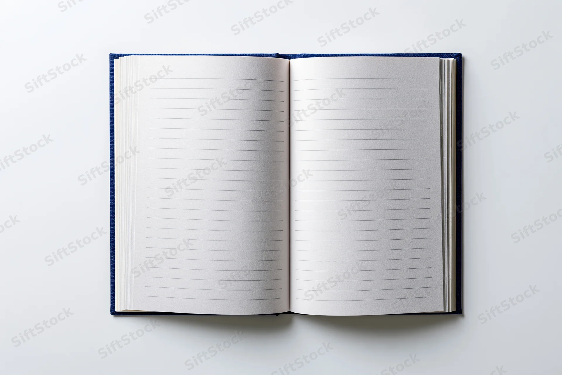 Open hardcover notebook with lined pages lying flat on white surface