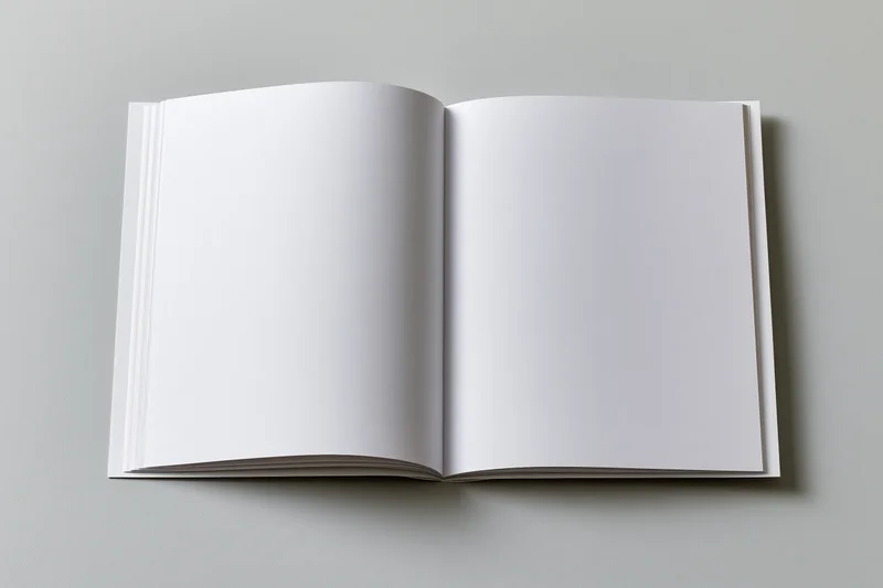 Open square-format booklet lying flat with blank white pages on gray surface