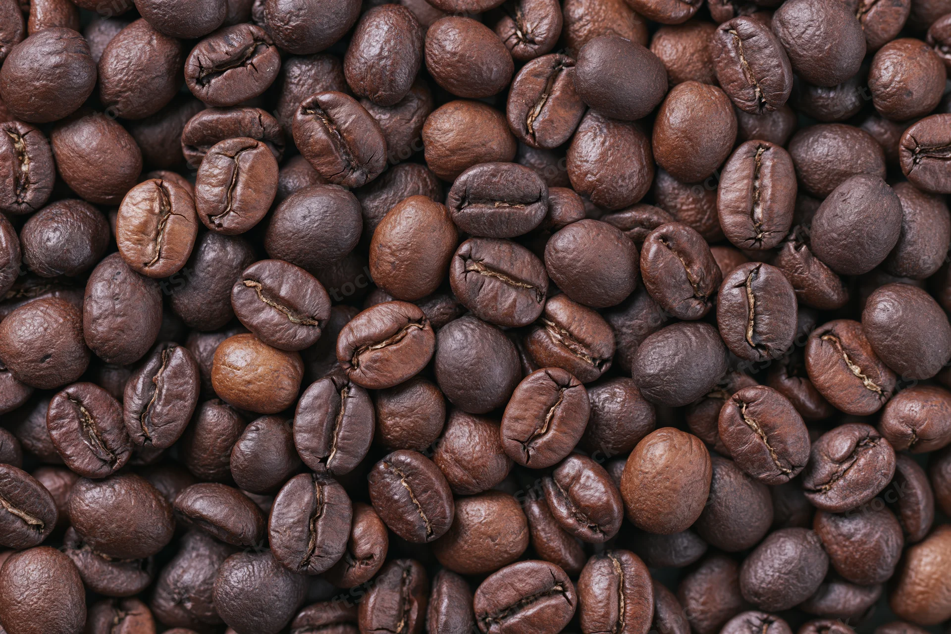 Roasted coffee beans filling the frame in an overhead flat lay view