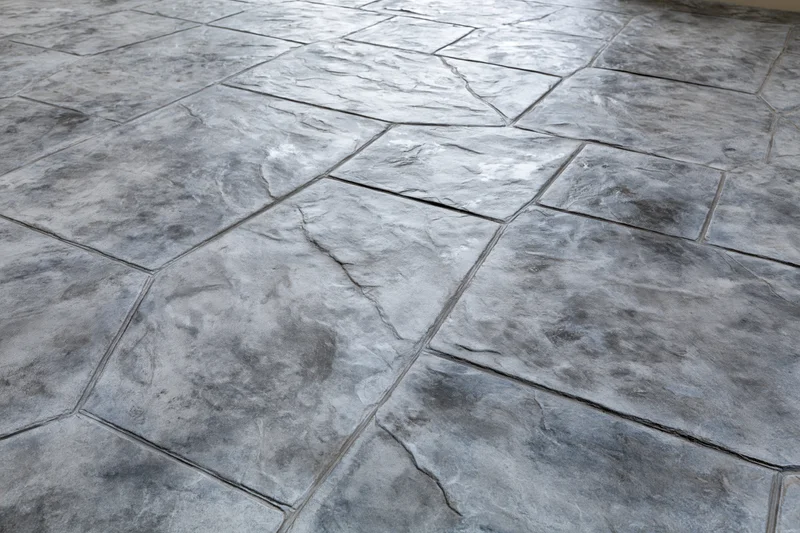 Stamped concrete flooring with irregular stone pattern for outdoor patio surface