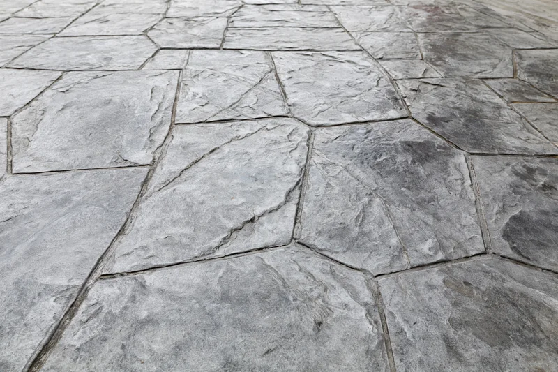 Stamped concrete pavement with irregular stone pattern for outdoor flooring