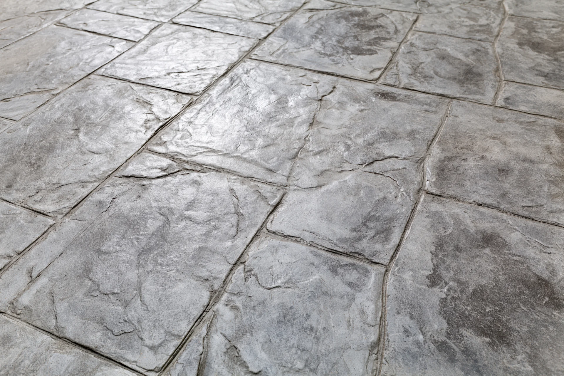 Stamped concrete pavement with irregular rectangular stone pattern for outdoor flooring