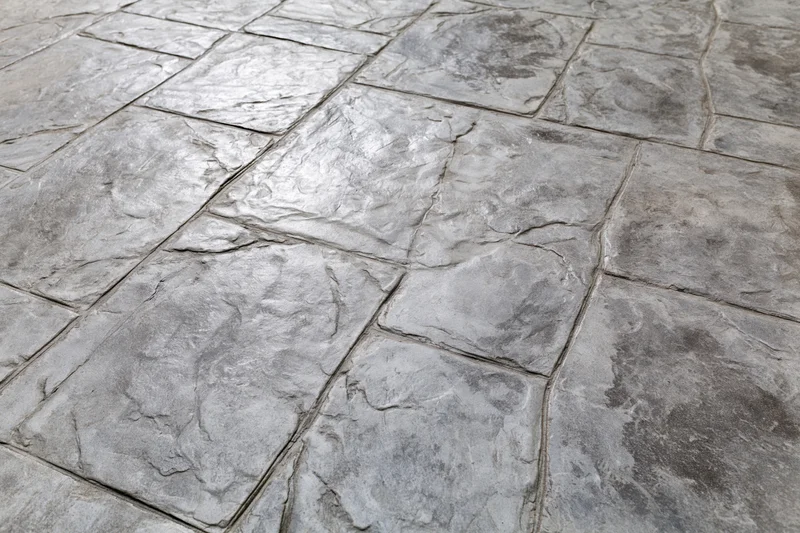 Stamped concrete pavement with irregular rectangular stone pattern for outdoor flooring