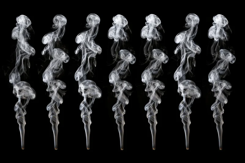White smoke plumes arranged in a grid against black background