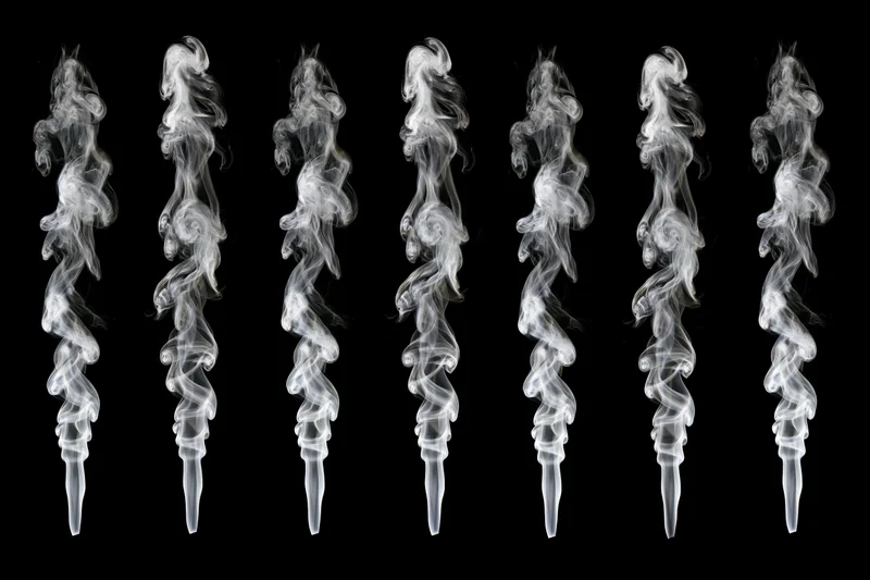 White smoke plumes curling upward in a grid against black background