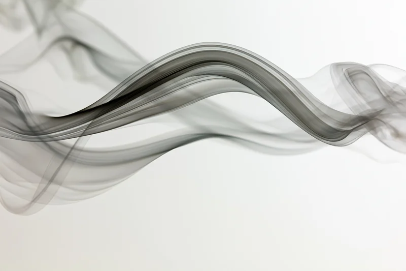 Flowing gray smoke drifting in curves across a white background