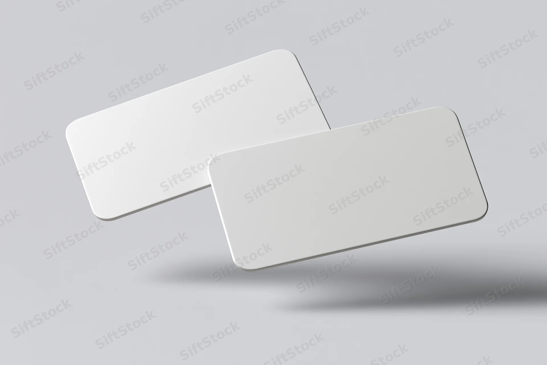 Two blank white business cards with rounded corners floating against a light gray background