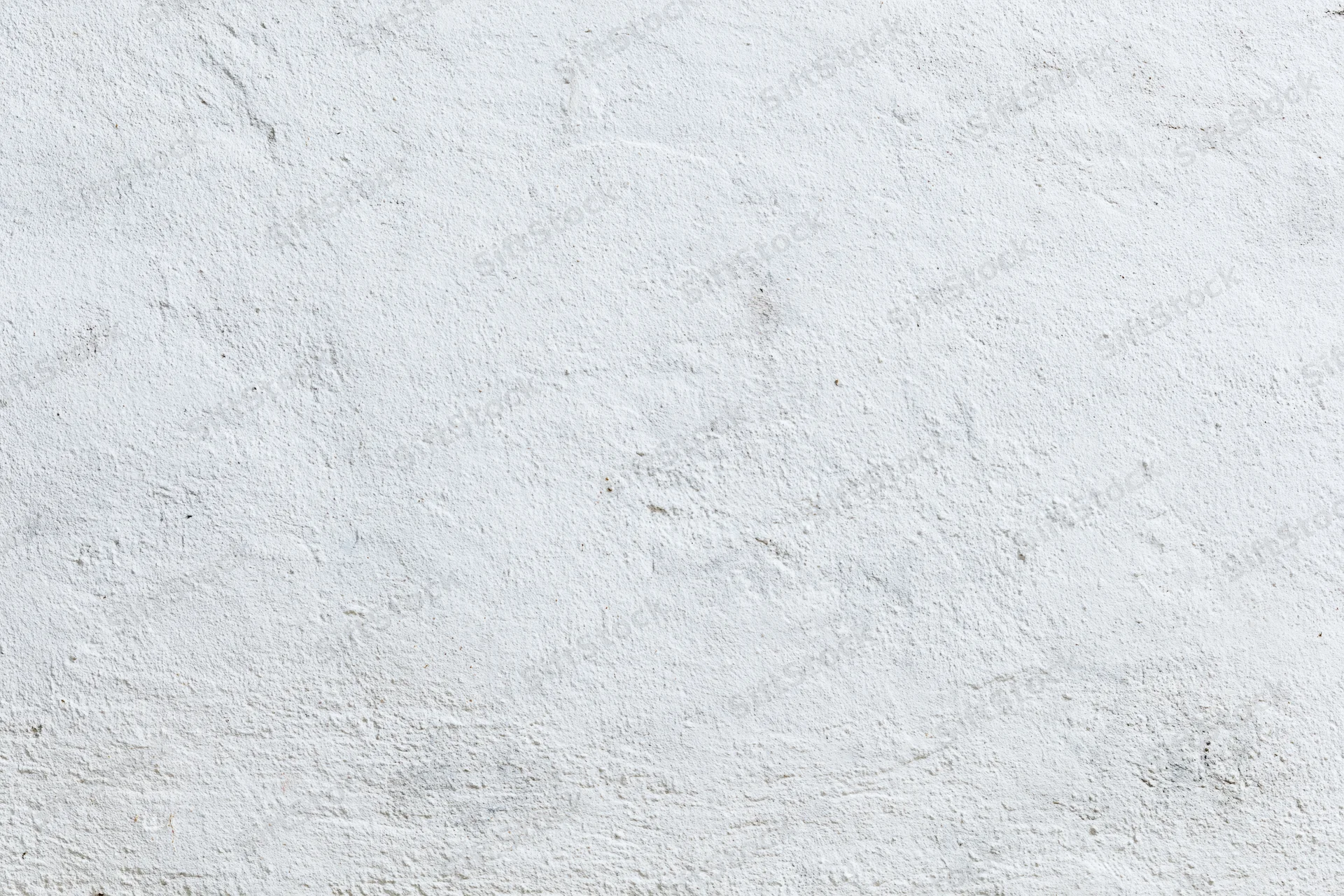 Weathered white concrete wall surface filling the frame