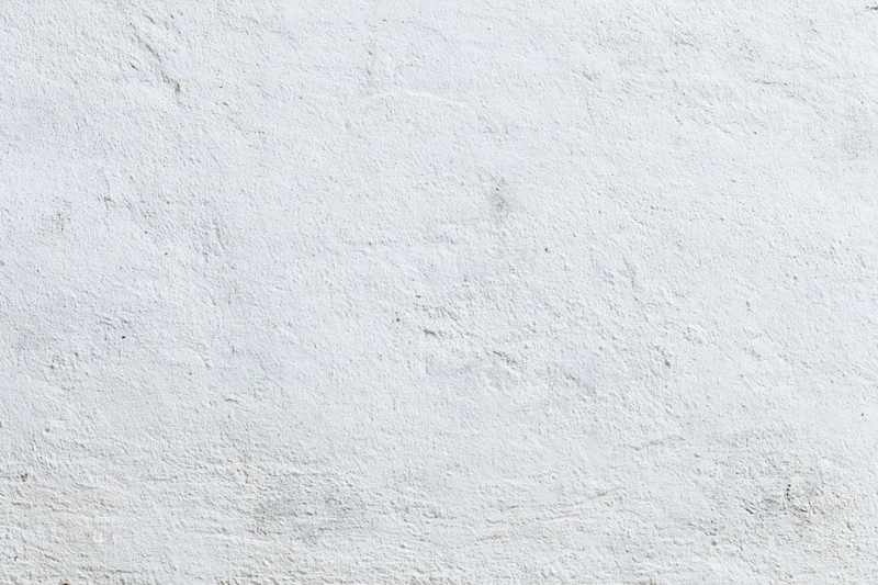 Weathered white concrete wall surface filling the frame