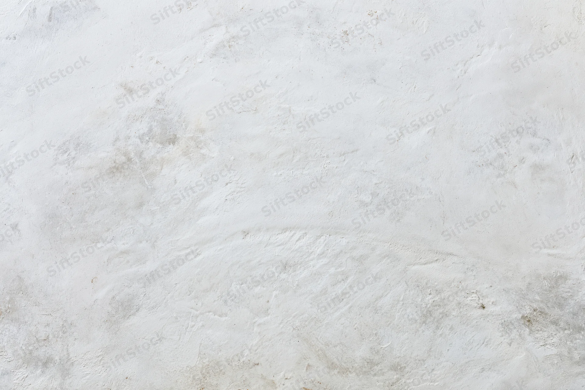 Weathered white concrete wall surface filling the frame