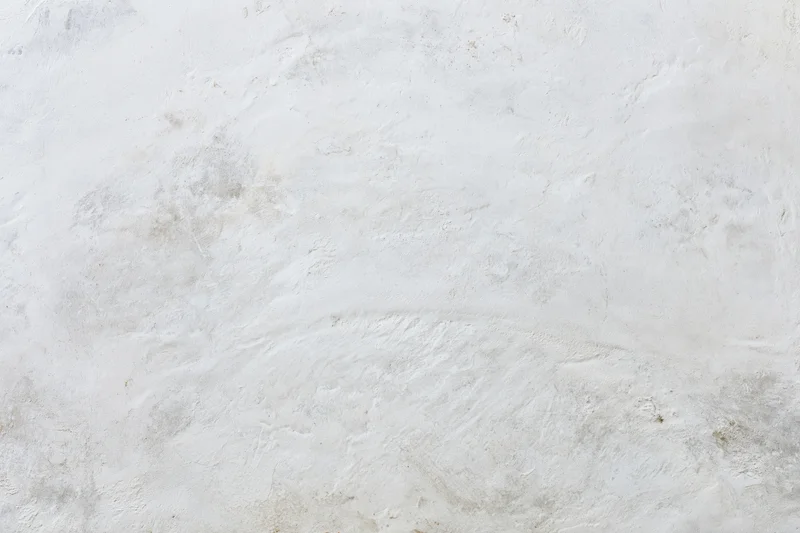 Weathered white concrete wall surface filling the frame