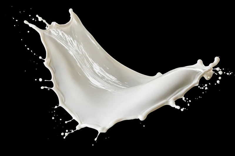 White milk splash frozen midair in sweeping arc shape against black background