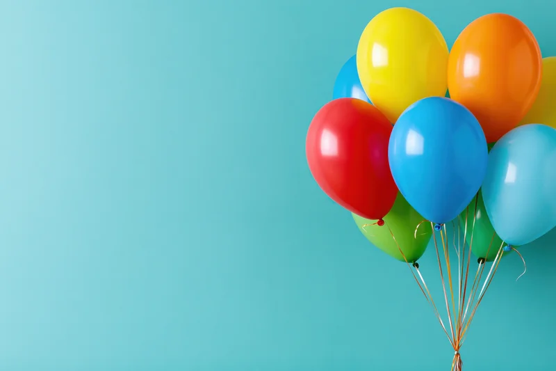 Colorful helium balloons clustered together on a solid blue background with copyspace on the left