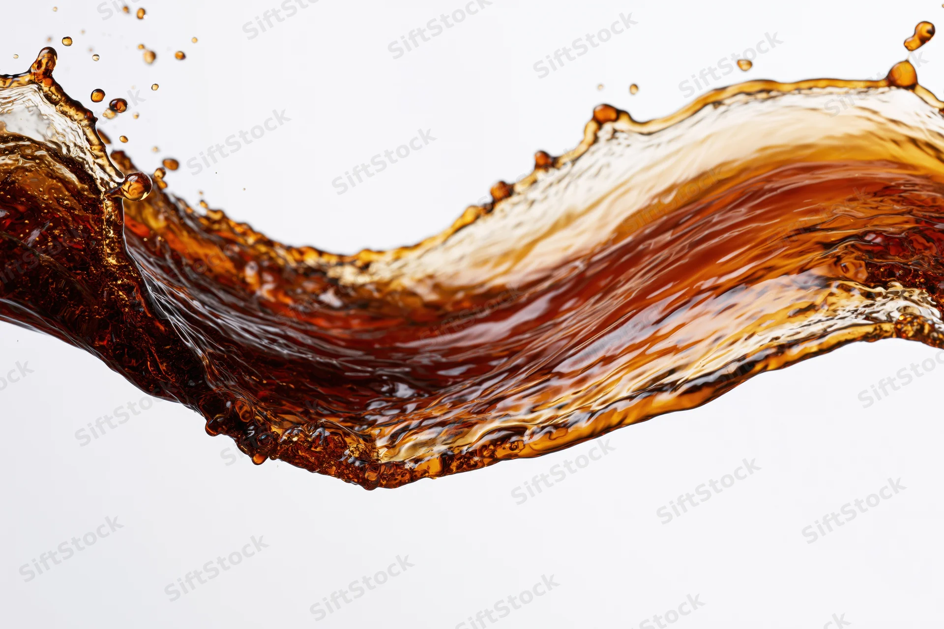 Dark amber liquid splashing midair in a dynamic arc against white background