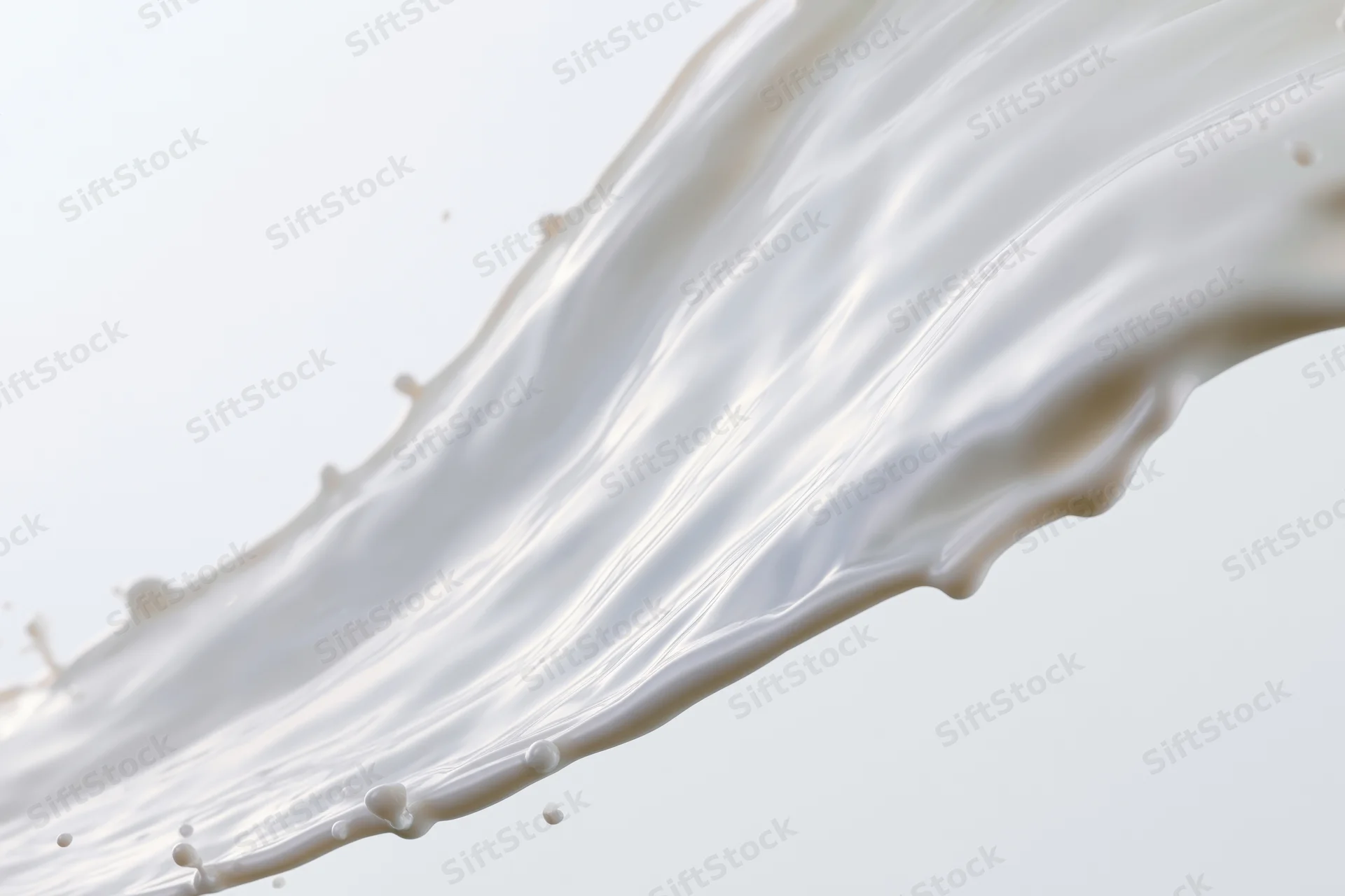 Flowing wave of white milk mid-splash against plain background