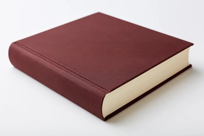 Hardcover book with plain dark reddish-brown cloth cover on white background