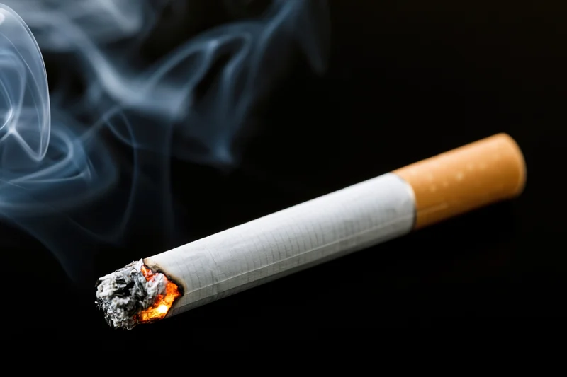 Cigarette in Ember: A Closeup of Burning Tobacco and Smoke