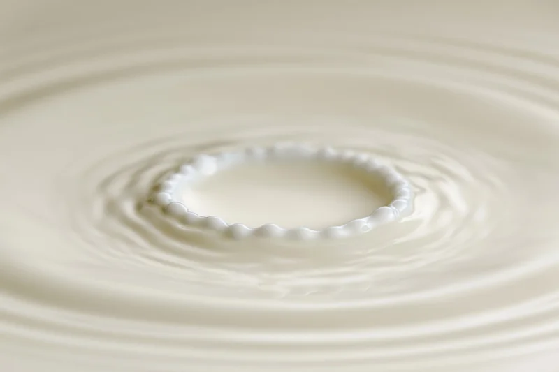 Milk drop creating crown splash on smooth surface