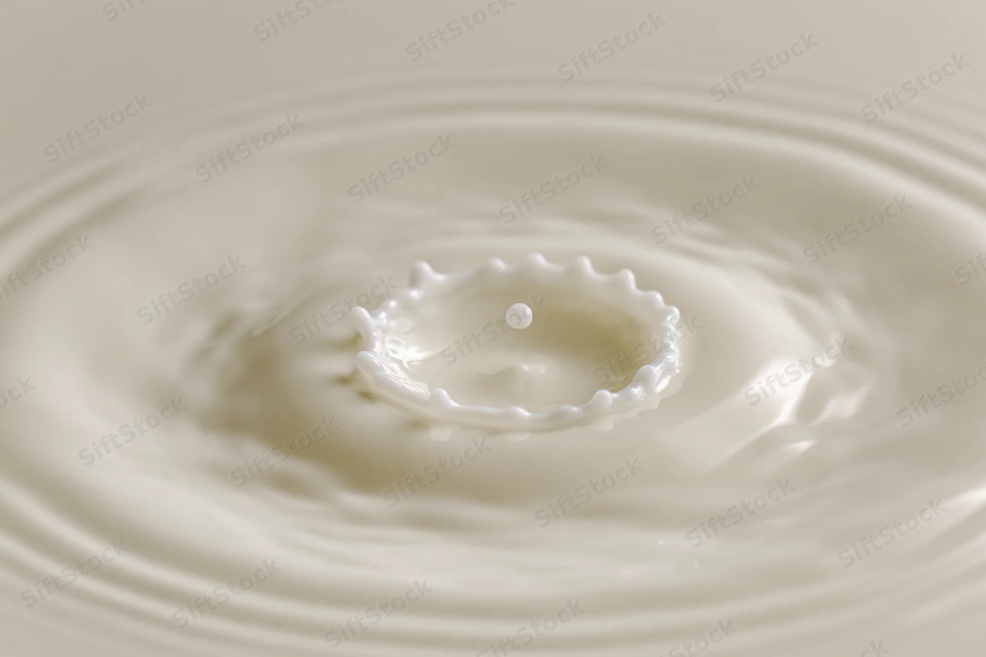 Milk drop creating crown splash on smooth surface