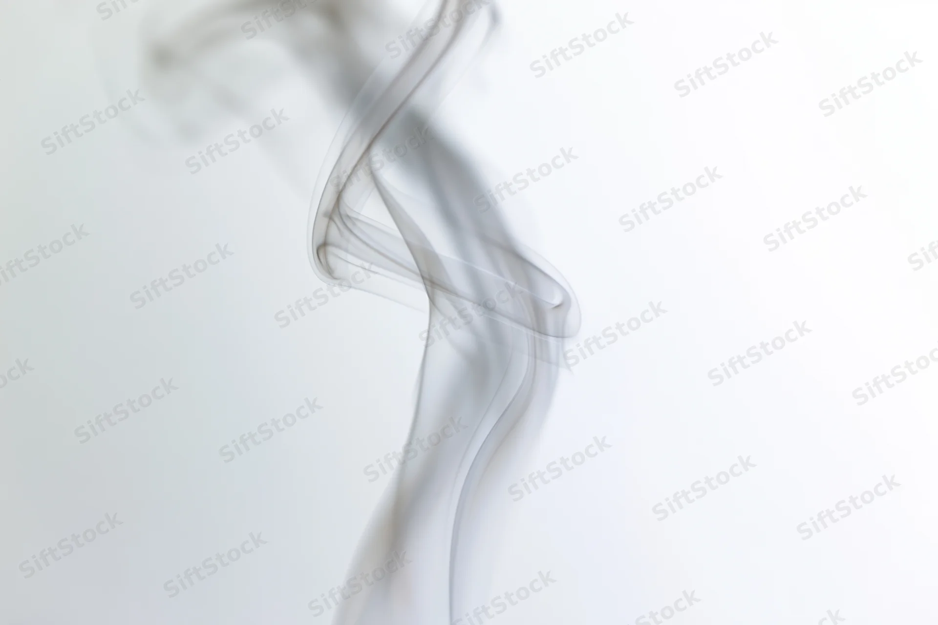 A single wisp of white smoke curling and twisting upward against a plain white background