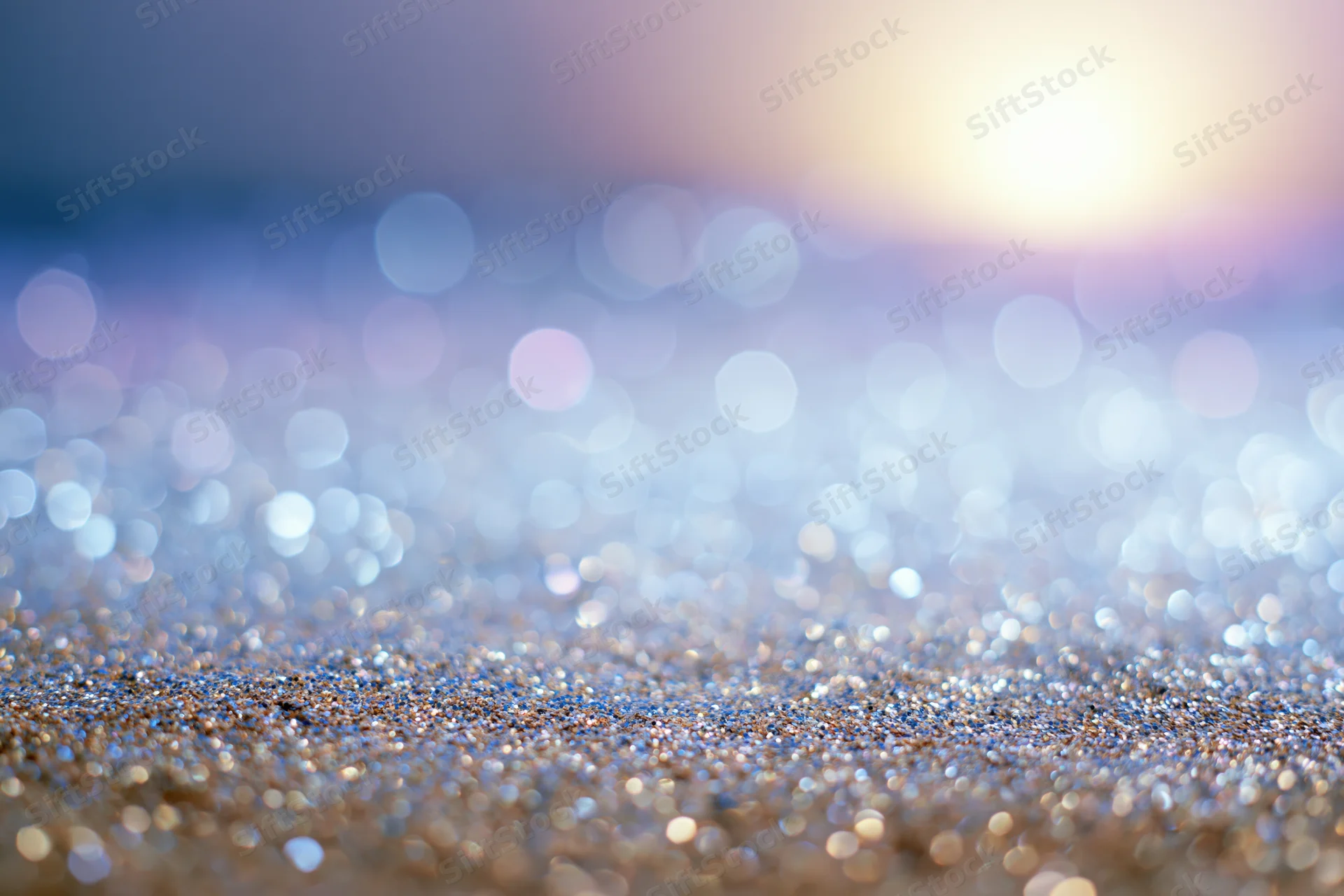 Abstract bokeh background with scattered light orbs and glittery texture