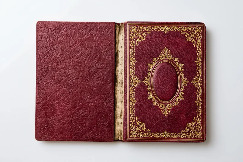 Antique book opened flat showing both crimson leather covers with gold embossed ornamentation