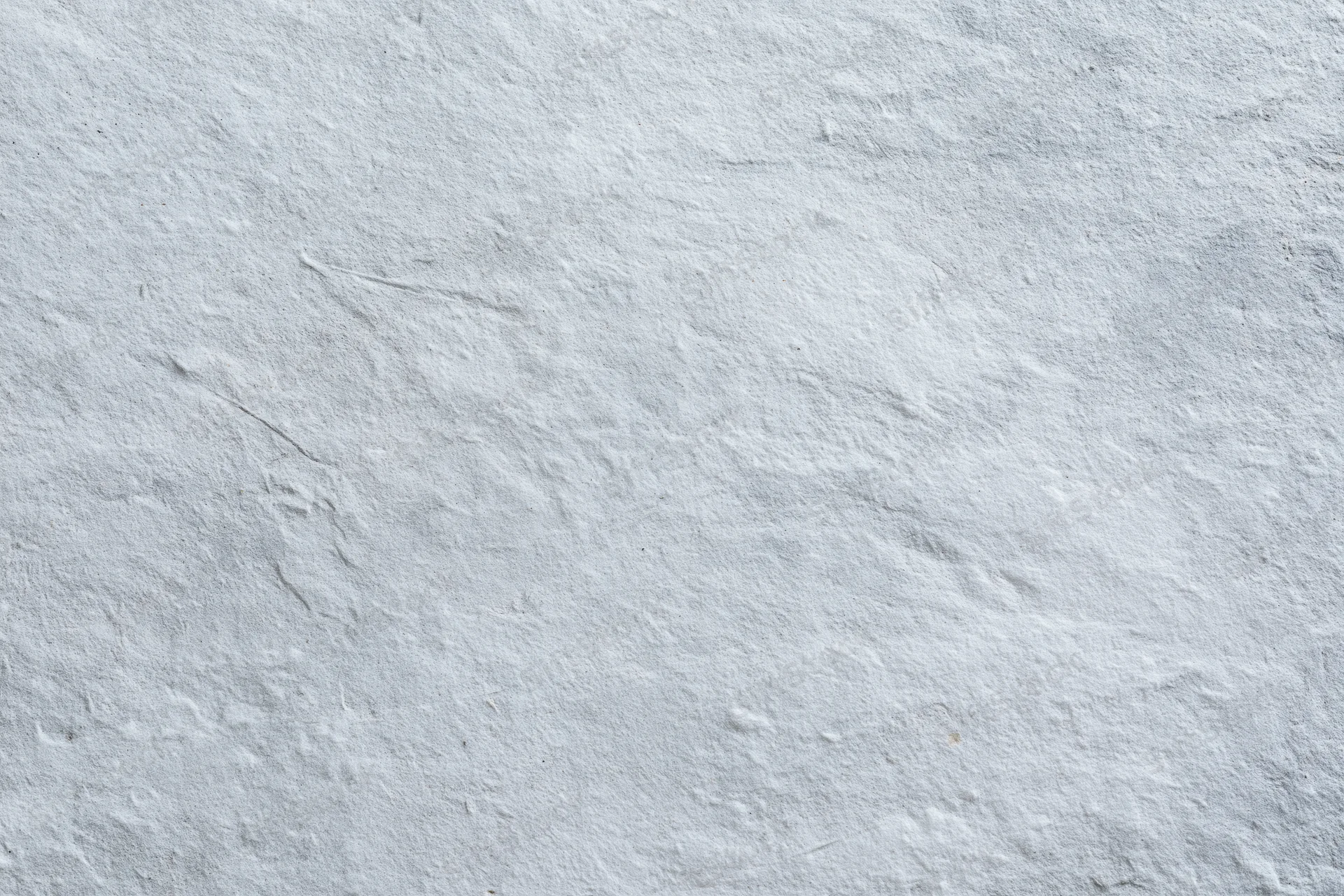 Close-up of a rough gray concrete wall surface filling the frame