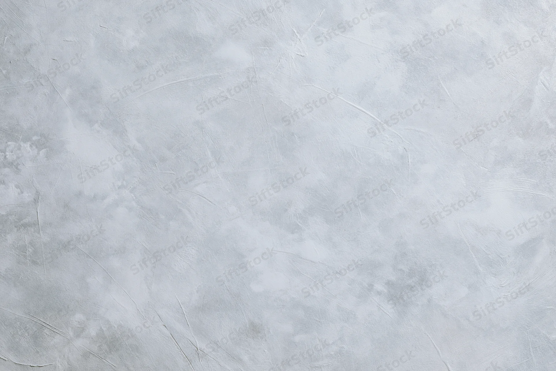 Gray concrete wall surface with textured finish filling the frame