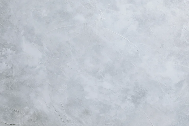 Gray concrete wall surface with textured finish filling the frame