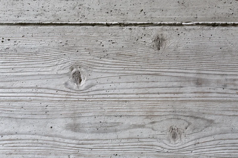 Board-formed concrete wall surface with wood grain texture and horizontal planks