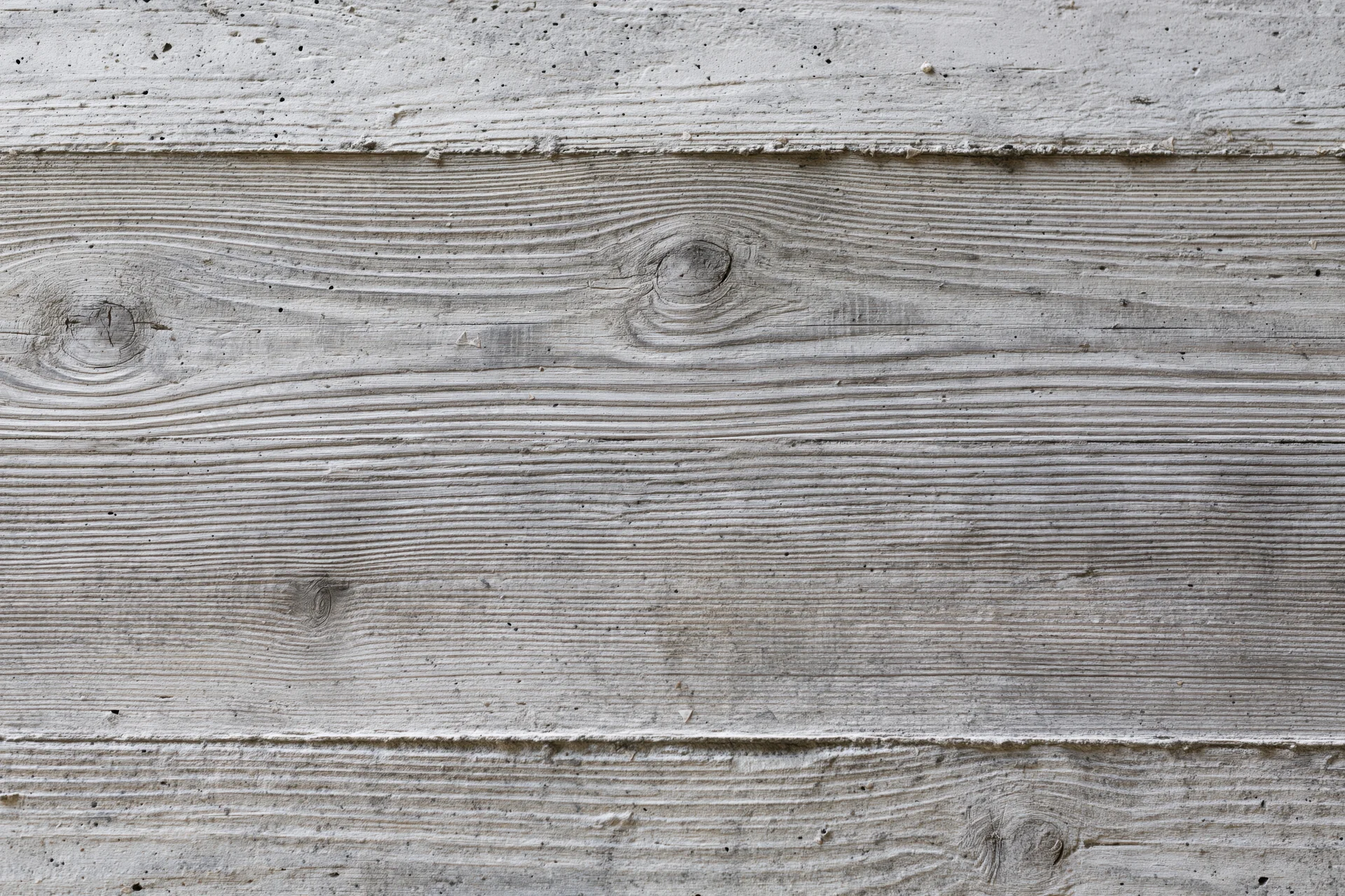 Board-formed concrete wall surface with horizontal texture and wood grain pattern