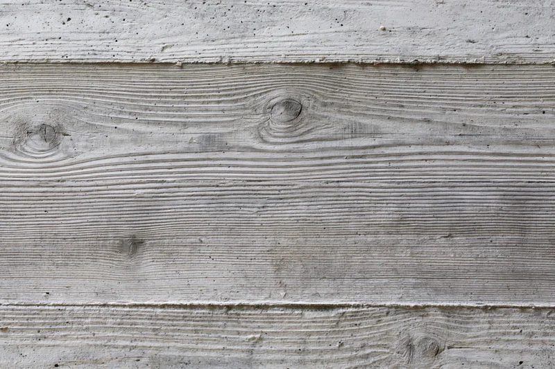 Board-formed concrete wall surface with horizontal texture and wood grain pattern