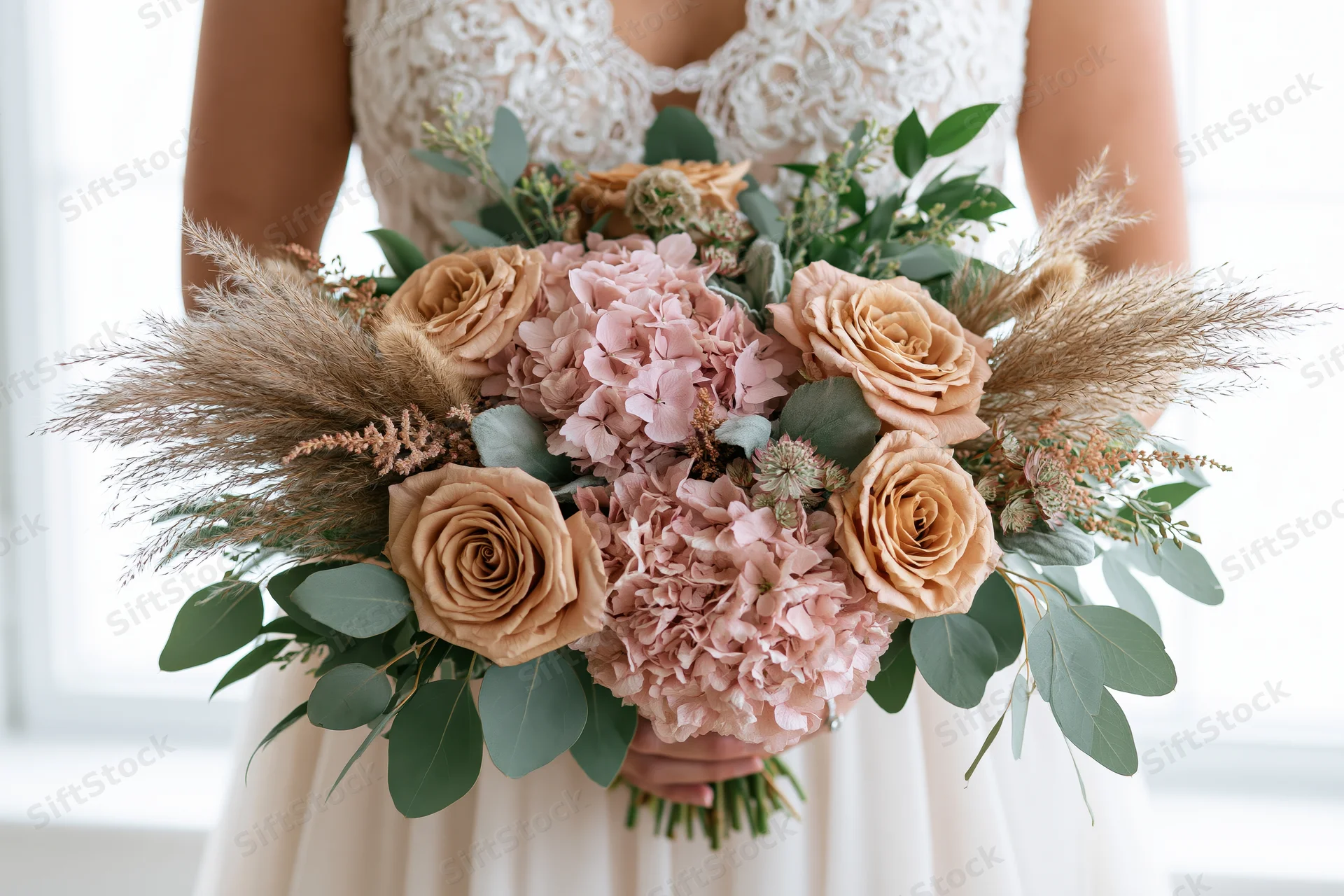 Bride holding a large floral bouquet in front of her body