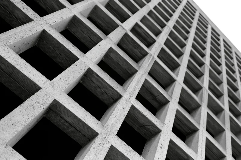 Low-angle view of a brutalist concrete grid facade on a building