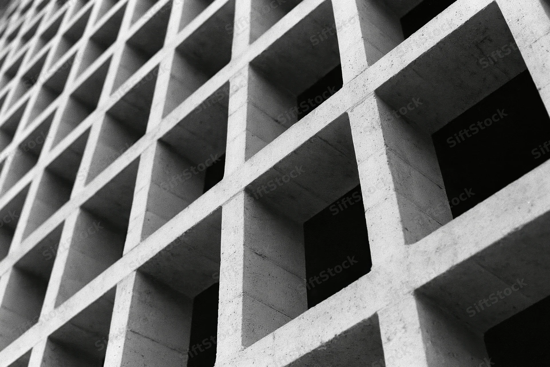 Close-up of a brutalist concrete grid structure viewed at an oblique angle