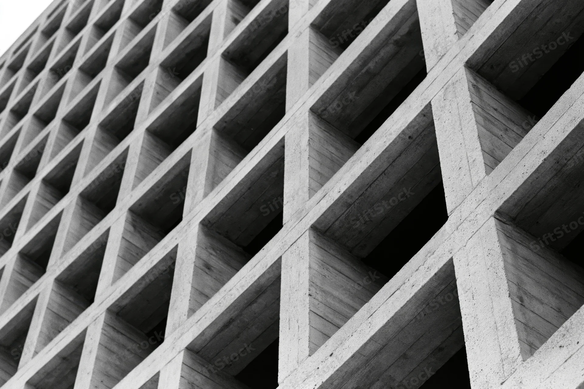 Close-up of a brutalist concrete grid structure viewed at an oblique angle