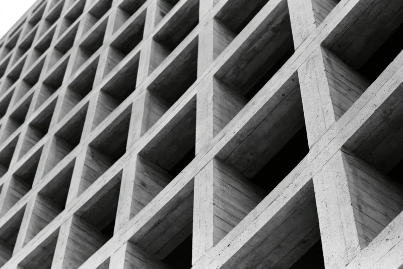 Close-up of a brutalist concrete grid structure viewed at an oblique angle