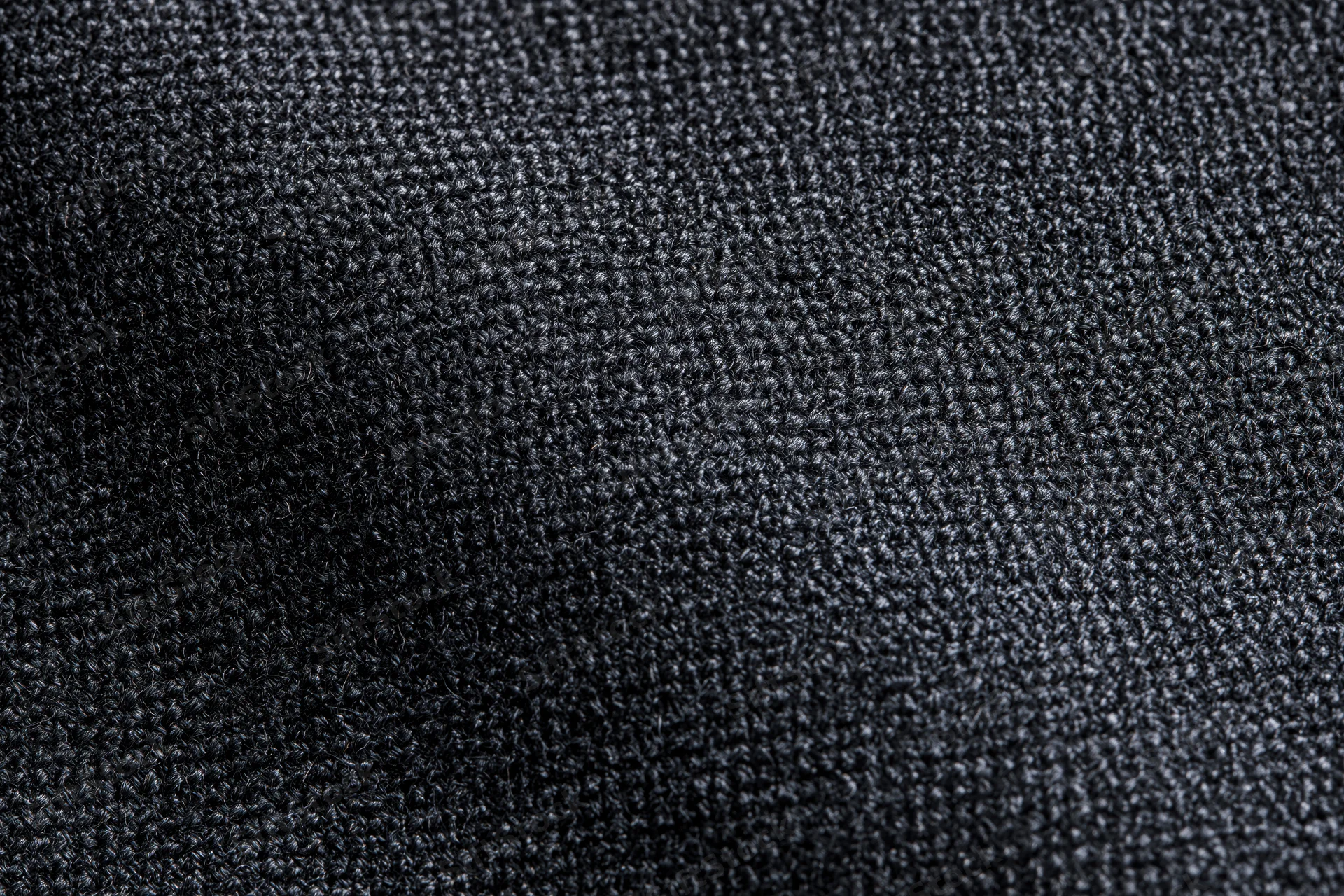 Close-up of dark charcoal woven fabric texture filling the frame