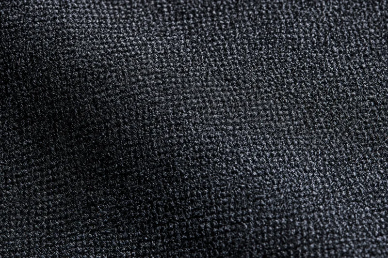 Close-up of dark charcoal woven fabric texture filling the frame