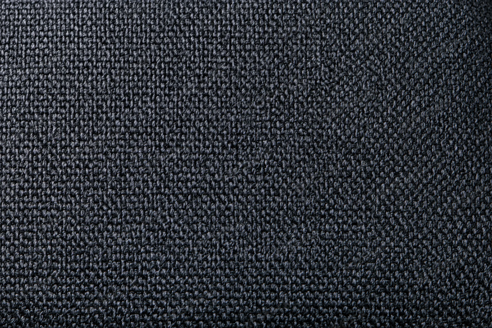 Close-up of dark charcoal woven fabric texture filling the frame