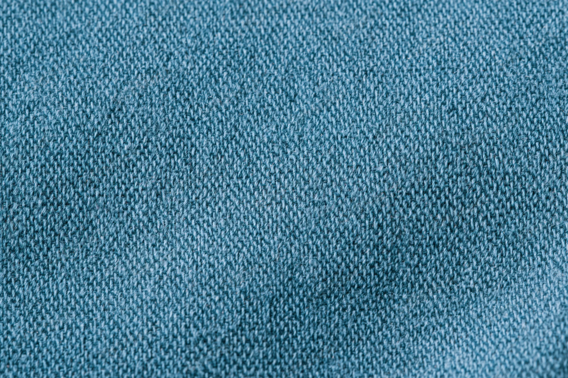 Close-up of blue woven cotton fabric texture filling the frame