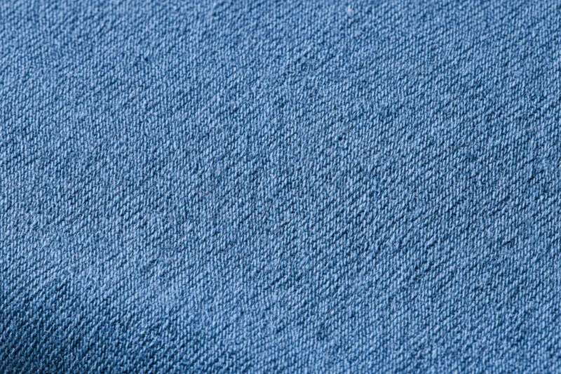 Close-up of blue woven cotton fabric texture filling the frame
