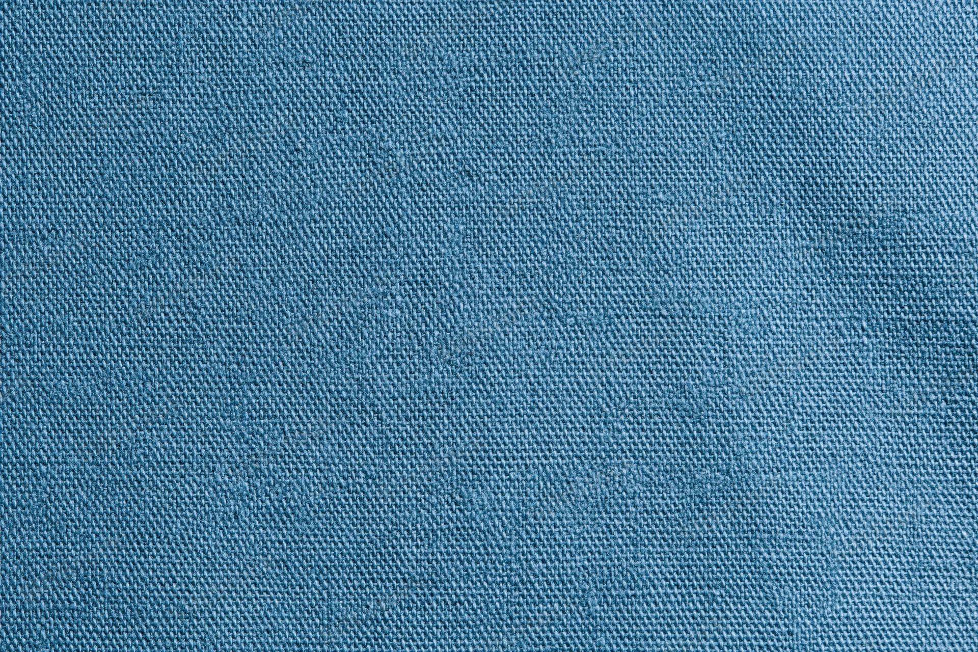 Close-up of blue woven cotton fabric texture filling the frame