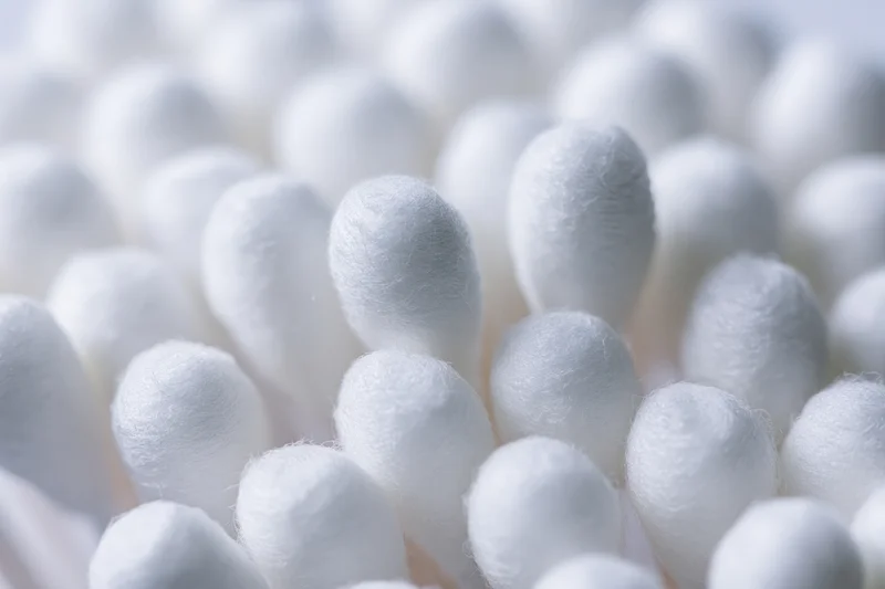 Close-up of white cotton swabs packed tightly together