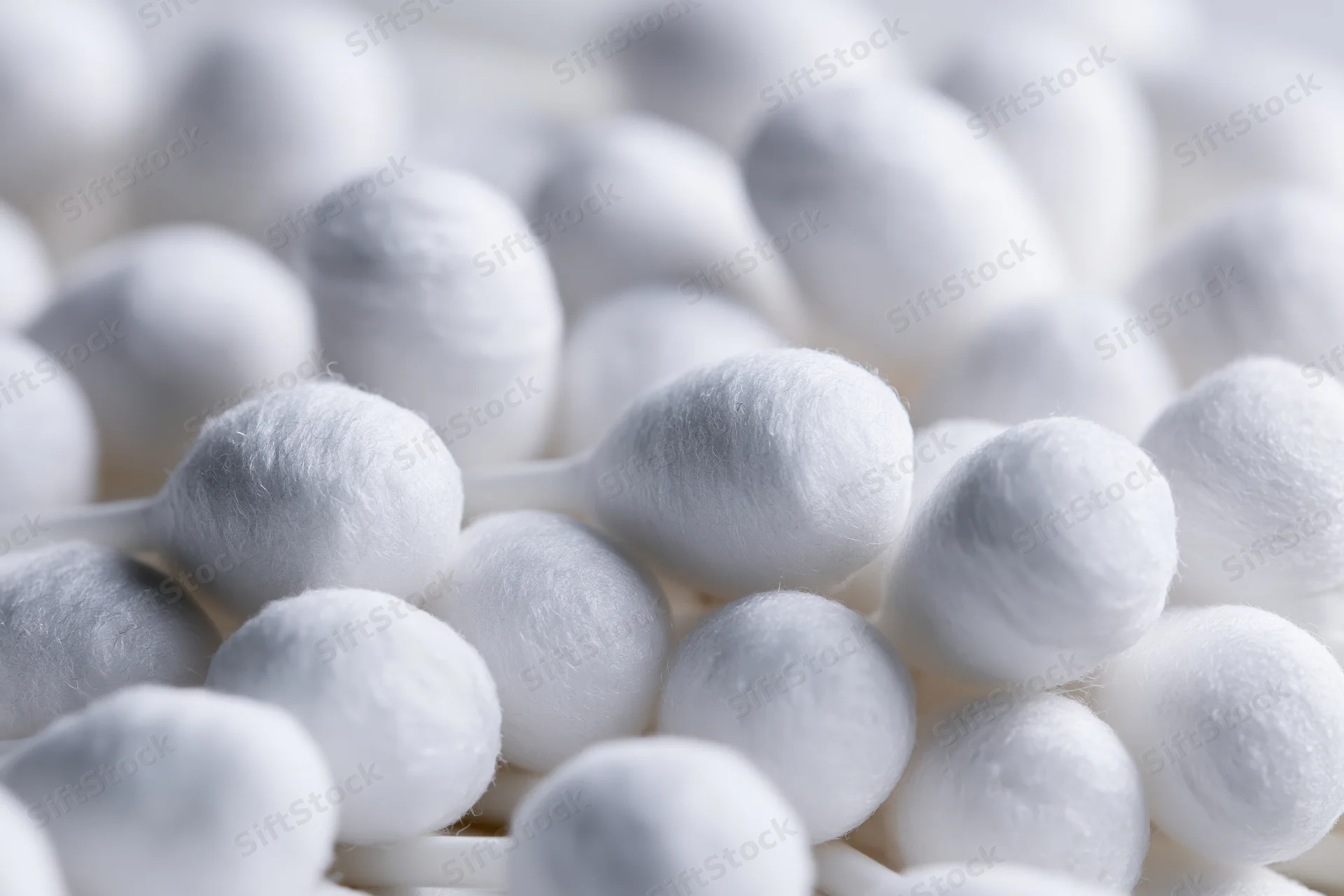 Close-up of white cotton swabs packed tightly together
