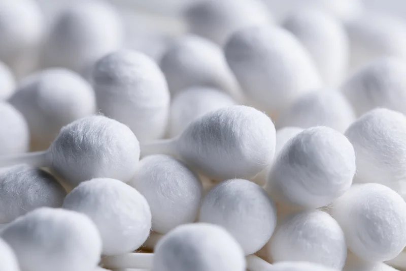 Close-up of white cotton swabs packed tightly together