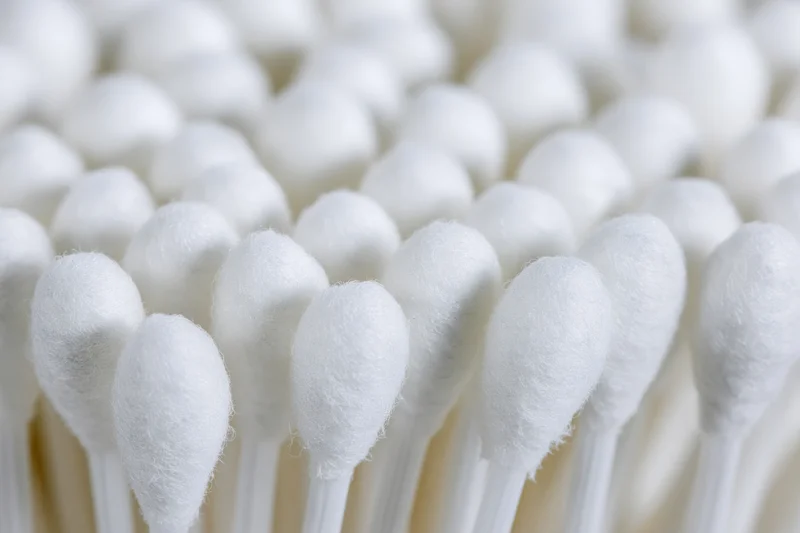 Close-up of white cotton swabs packed tightly together