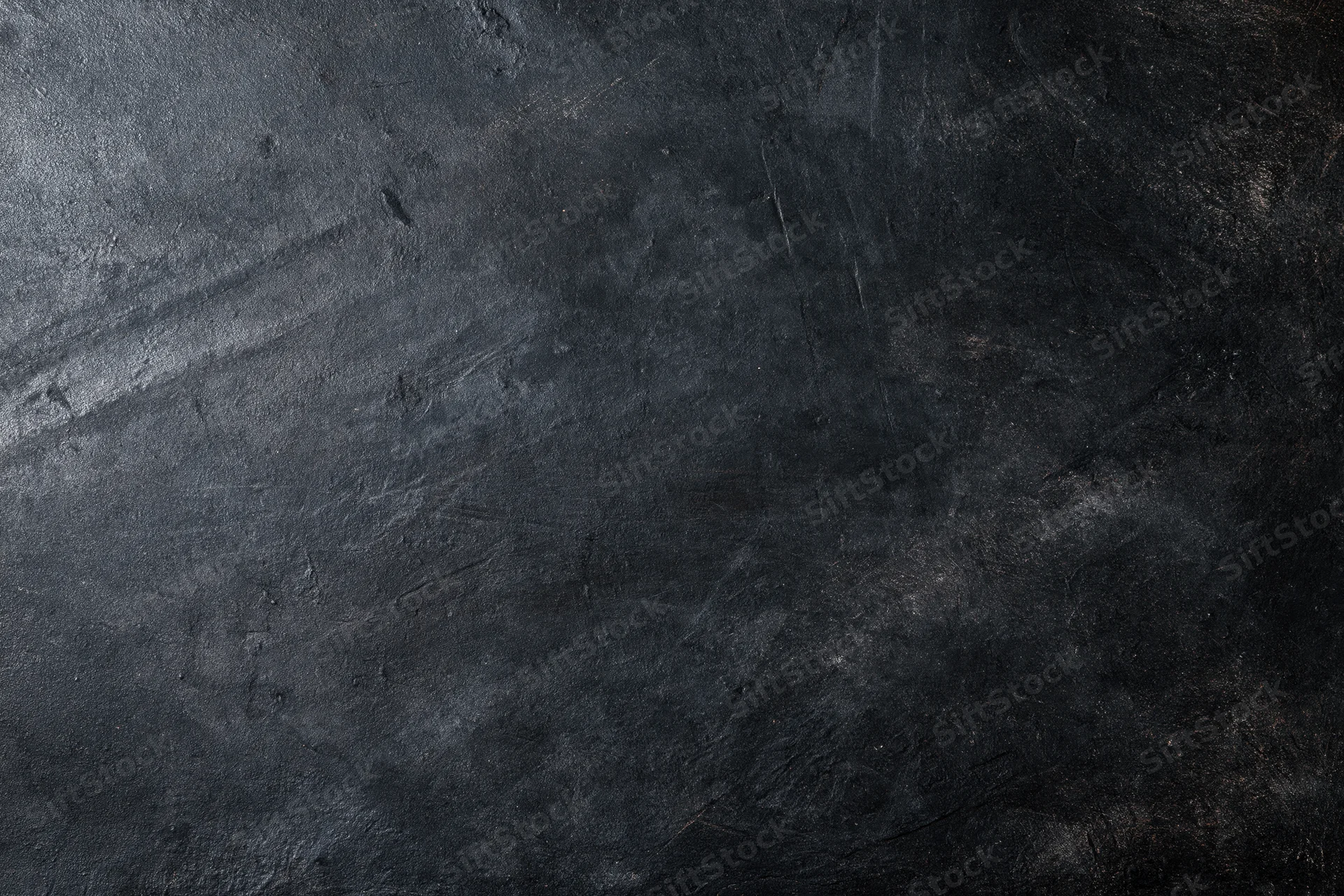 Dark weathered concrete wall surface filling the frame