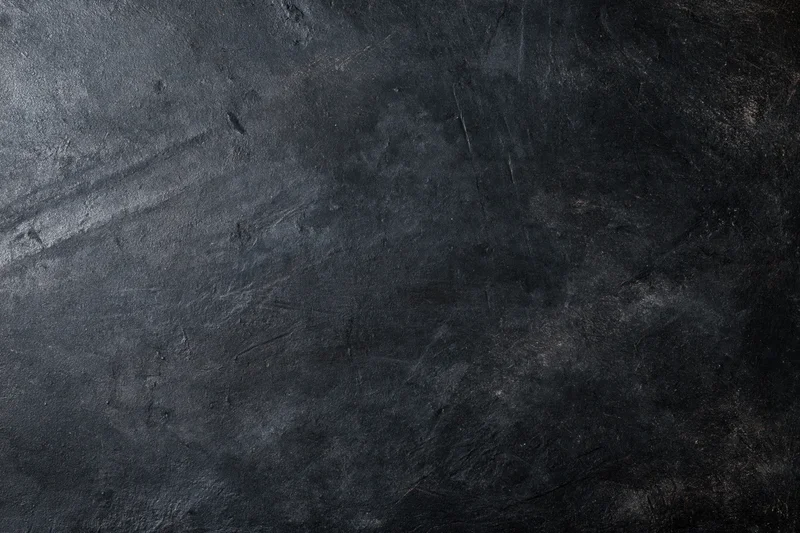 Dark weathered concrete wall surface filling the frame