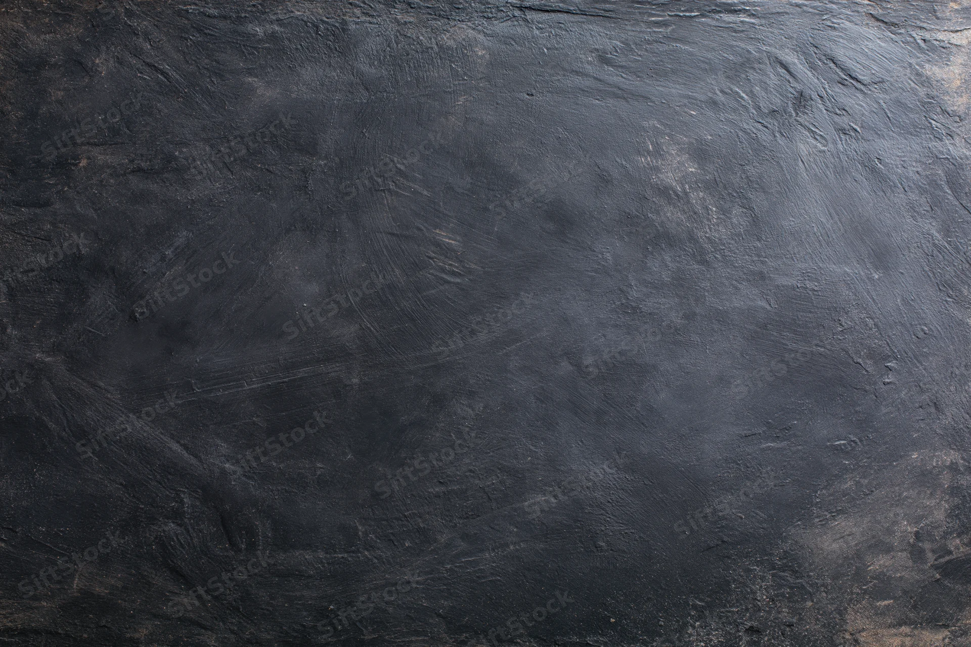 Dark weathered concrete wall surface filling the frame